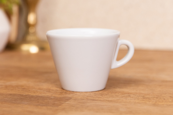 A Favorita Cappuccino mug sitting on a countertop.