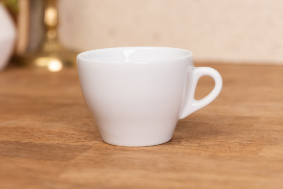 A Torino Cappuccino mug sitting on a countertop.