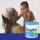Parent holding smiling baby beside Desitin Daily Defense diaper rash cream jar
