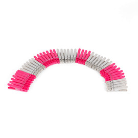 Pack of pink and grey plastic clothes pegs arranged in an arc, product image.