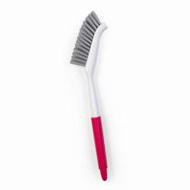Dish brush with pink handle and grey bristles, shown on white background