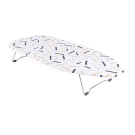 Foldable tabletop ironing board with white patterned cover and metal legs
