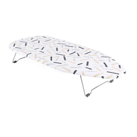 Foldable tabletop ironing board with white patterned cover and metal legs