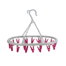 White circular hanging clothes airer with pink pegs for drying socks or small items