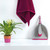 Set: magenta cleaning towel, grey dustpan and brush, and pink plant pot on shelf