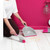 Grey and pink dustpan and brush set in use on light wooden floor