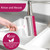 Reusable window squeegee being rinsed under a tap, white with pink blade.