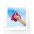 Person cleaning window with pink cloth against blue sky