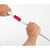 Hands twisting white pole with pink connector, product feature close-up