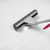 Grey microfibre mop with pink handle cleaning white tiled floor, shown with scrubbing brush attached.