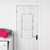 White metal over door airer with three tiers, hanging on door in laundry room