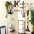Home cleaning kit including mop, broom, dustpan, and cordless vacuum, shown on wall display.