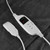 Electric heated blanket controller on soft dark grey fabric