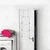 White over-door drying rack attached to door in laundry room, shown with washing machine.