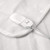 White electric heated blanket close-up showing controller attached