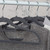 Set of grey clothes hangers with assorted tops on a rail