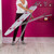 Full size ironing board with grey geometric cover in pink themed room