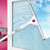 White and silver window squeegee cleaning glass with blue sky reflected