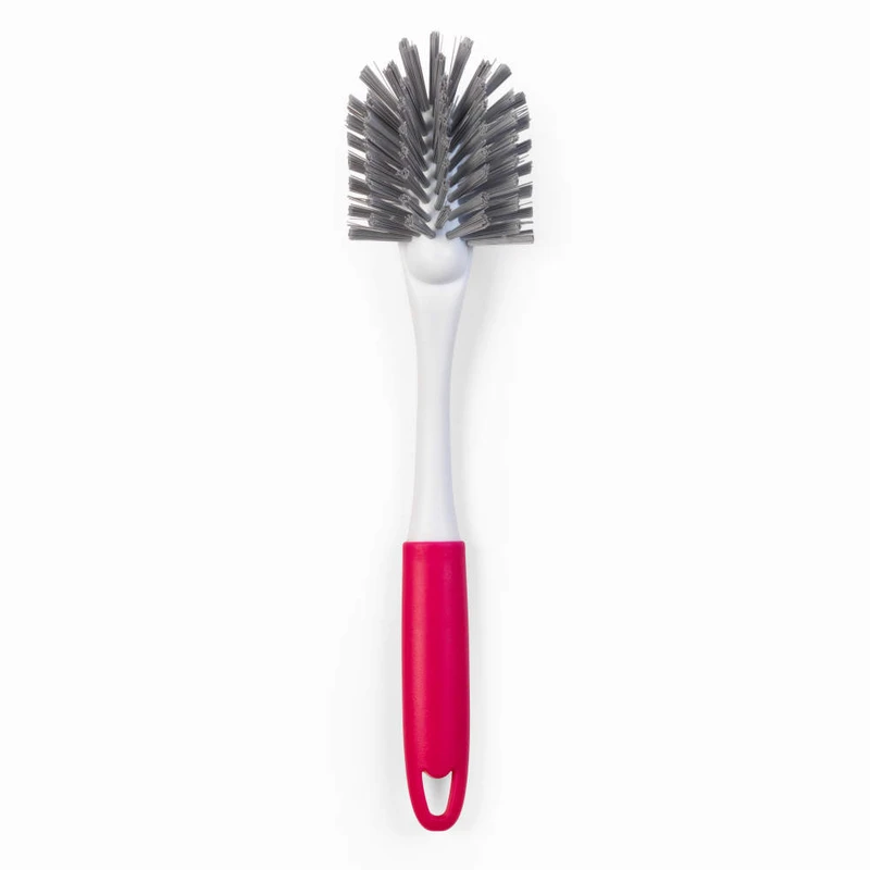 Dish brush with angled grey bristles and pink handle, shown on white background