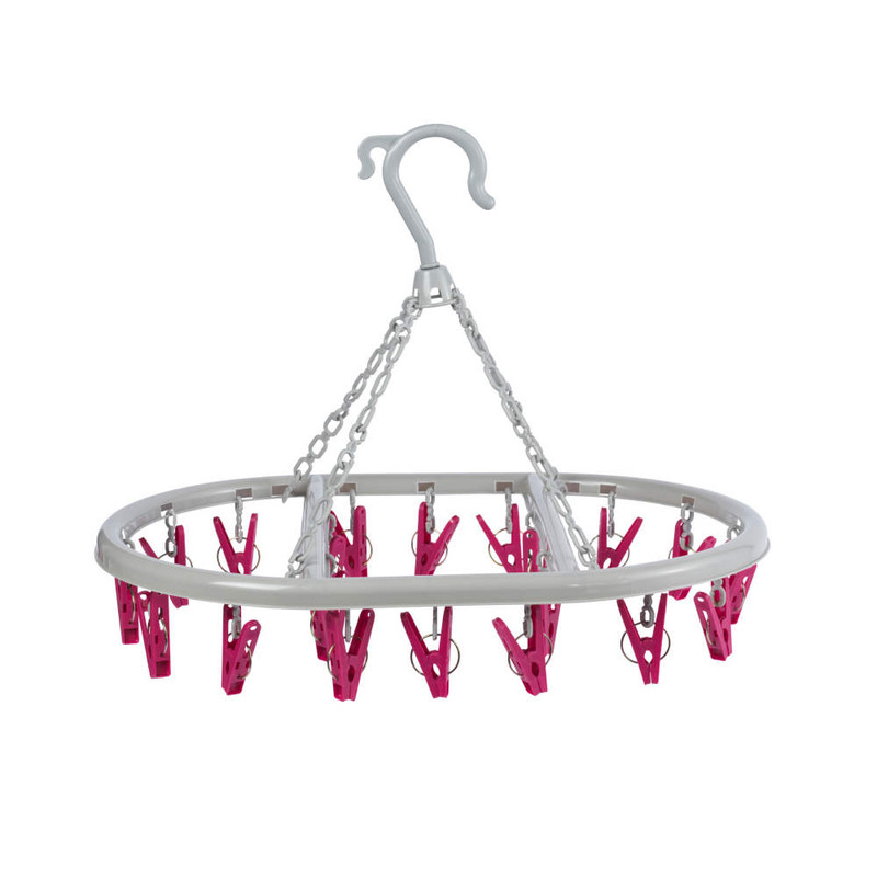 White circular hanging clothes airer with pink pegs for drying socks or small items