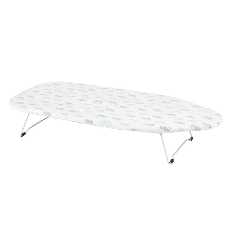 White tabletop ironing board with geometric patterned cover, foldable legs
