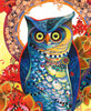 Close up of Hooty wooden jigsaw puzzle featuring a blue owl with bright green eyes and patterns throughout its feathers. Red autumn florals sit in front of the owl as twigs and leaves swirl behind the creature, creating a halo around the back of its head. The yellow background adds sunshine to this wildlife scene.