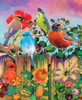 Close up of a wooden jigsaw puzzle titled "Birds And Blooms," featuring a variety of birds, including cardinals and sparrows, atop a wooden fence overflowing with colorful flowers.