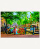 Red Bike In Amsterdam wooden jigsaw puzzle features a red bicycle parked on a shady brick pathway along a canal.  The canal stretches down through the middle of the image, with buildings and trees running along each side of it. Cars are parked on the side of the road and boats sit floating in the canal, while people walk around Amsterdam.