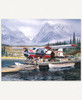 Last Chance wooden jigsaw puzzle presents a lake by the snow-covered mountains where a plane is getting loaded with boxes of supplies, and a little boy fishes off the dock.