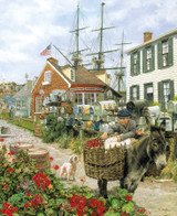 Close up of Mystic Memories wooden jigsaw puzzle brings you back in time to a summer day in the ship-building village of Mystic, Connecticut. The cobblestone pathway in between the houses leads to a fishing boat tied to a dock in the marina. A ship's masts stand tall behind a brick house with an American flag waving in the wind. 