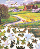  Pieces taken apart of Sunday Ride wooden jigsaw puzzle, presenting a spring scene on a farm, where a family can be seen riding horses as their dog follows along. There is a farmhouse at the bottom of the image, as viewers follow along the dirt path next to a white fence, it leads to another farmhouse with flower bushes and a barn in the center. Wide open fields surround the property and trees following along the top of the hill's horizon line. Pink fluffy clouds fill the sky above. 