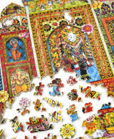  Pieces taken apart of Taj Mahal wooden jigsaw puzzle displays the mausoleum decorated with colorful floral prints. In the doorway stands a man with an elephant, while each window features a person. 