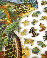  Pieces taken apart of World Of The Sea Turtle wooden jigsaw puzzle capturing a sea turtle resting on the ocean floor with its hatchlings, surrounded by seashells, a crab, horseshoe crab, and starfish. On the turtle's shell is an image of fish and other aquatic life swimming in a coral reef. 