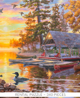  Close-up of Canoe Camp Buffalo wooden jigsaw puzzle unveiling an autumn evening of a lake view property. Two people take a canoe ride on the lake as the sun sets, reflecting vibrant pastel colors on the water. A moose stands on the shore line watching the boat as ducks swim near canoes lining the perimeter of a boat dock. Adirondack chairs surround a fire pit off the side of a cabin. 