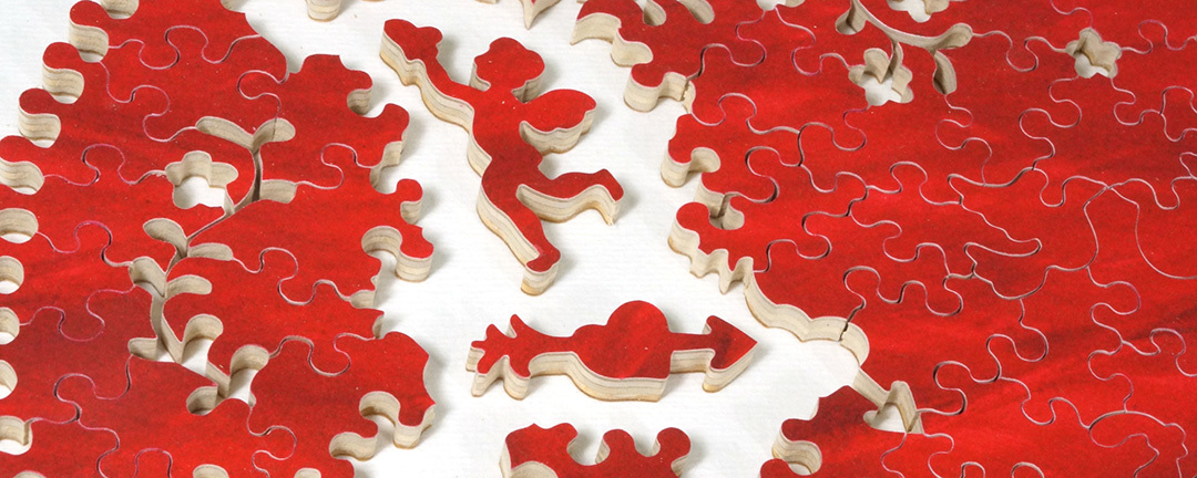 close up shot of a all red cut heart puzzle with cut outs of flowers