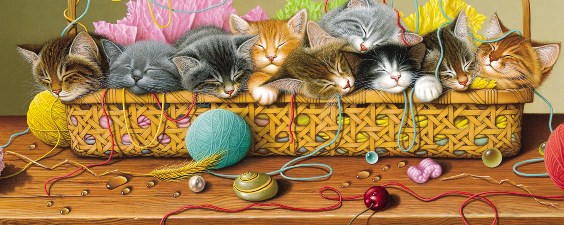 a litter of nine baby kittens sleeping in a basket of yarn on a tabletop
