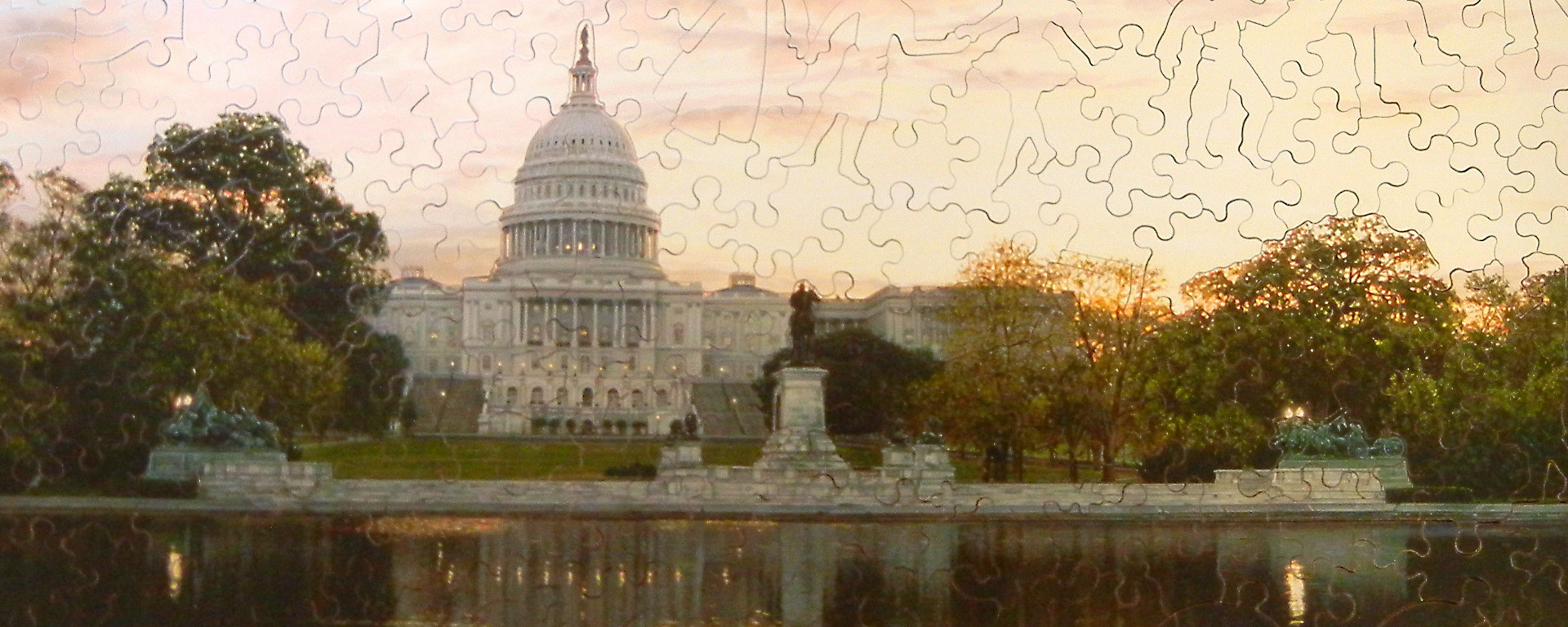 Wooden Washington DC puzzle featuring the sun setting behind the majestic United States Capitol building, with its grand dome and classical architecture.