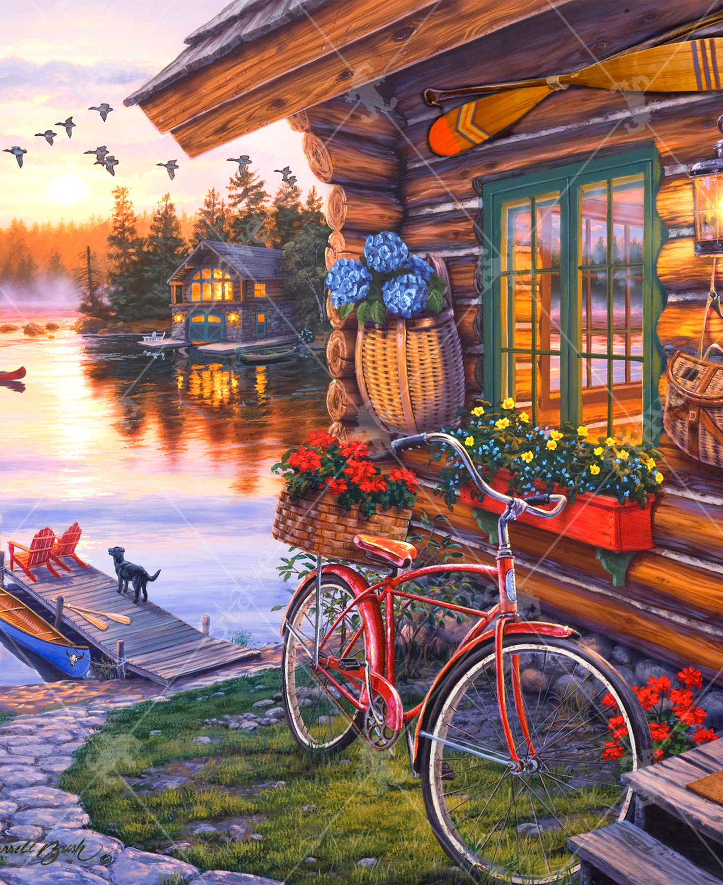 Close-up of Away From It All wooden jigsaw puzzle featuring a log cabin on the lake, with its door half open and a fire blazing inside. There is a path that leads to a boat dock, where a dog stands looking out towards the water as its owner takes a canoe out for a ride as the sun sets. A flock of geese fly overhead and another cabin's lights glow in between the pine trees.