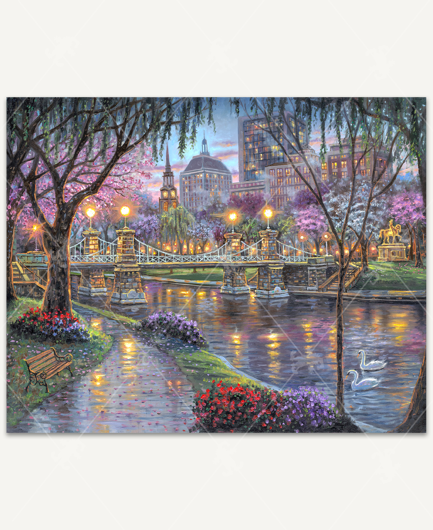 Chesapeake Bay wooden jigsaw puzzle showcases an evening scene in the park along the bay. Trees and flowers bloom as petals fall on a pathway leading to a bridge. Across the bridge is a statue of a man on horseback with city buildings in the background.