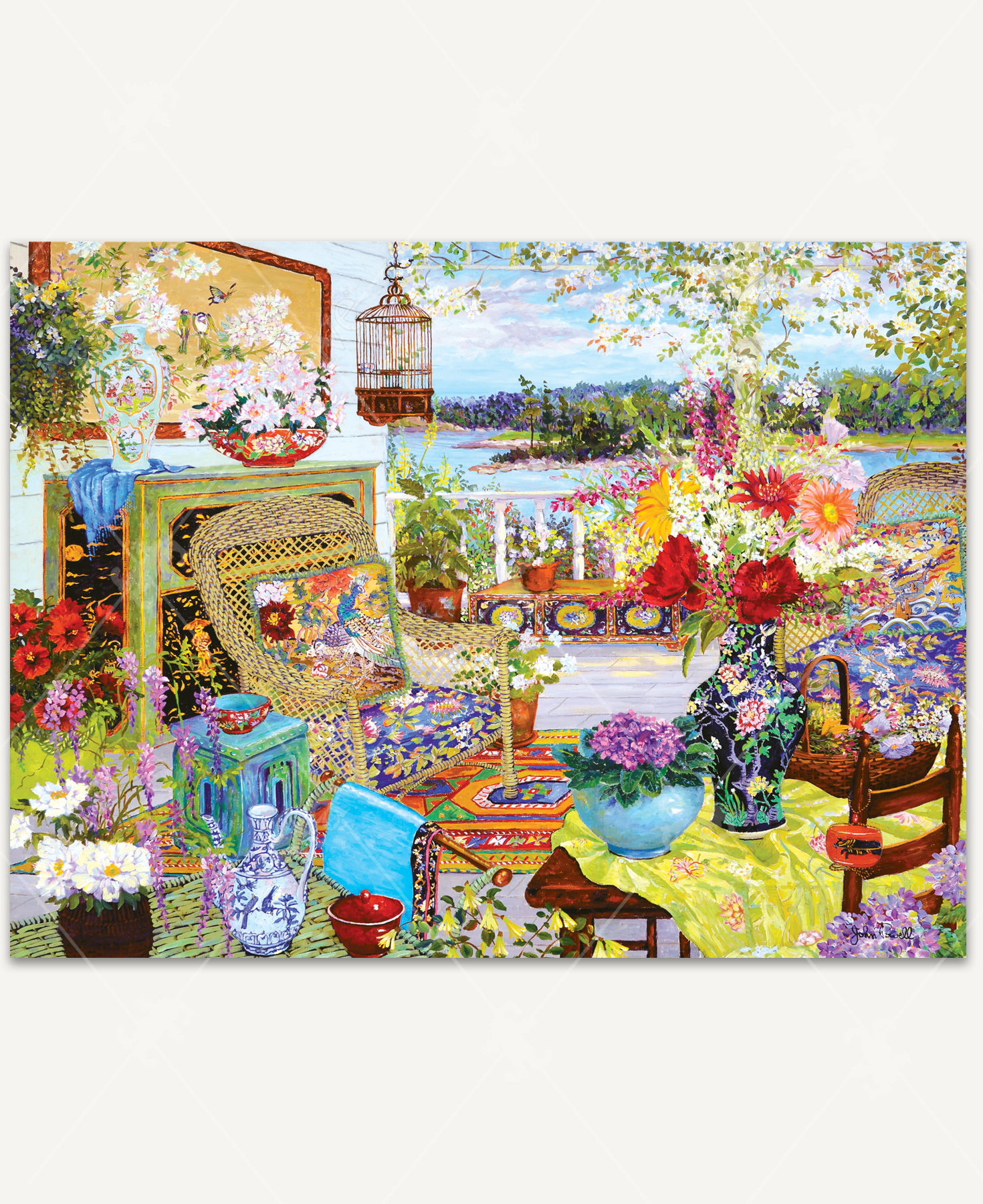 Summer Light wooden jigsaw puzzle reveals a wicker and floral porch oasis on the banks of a lake on a summer day. Freshly cut flowers in decorated vases and pots complement the furniture, pillows, and rug, making this a colorful and aromatic scene.