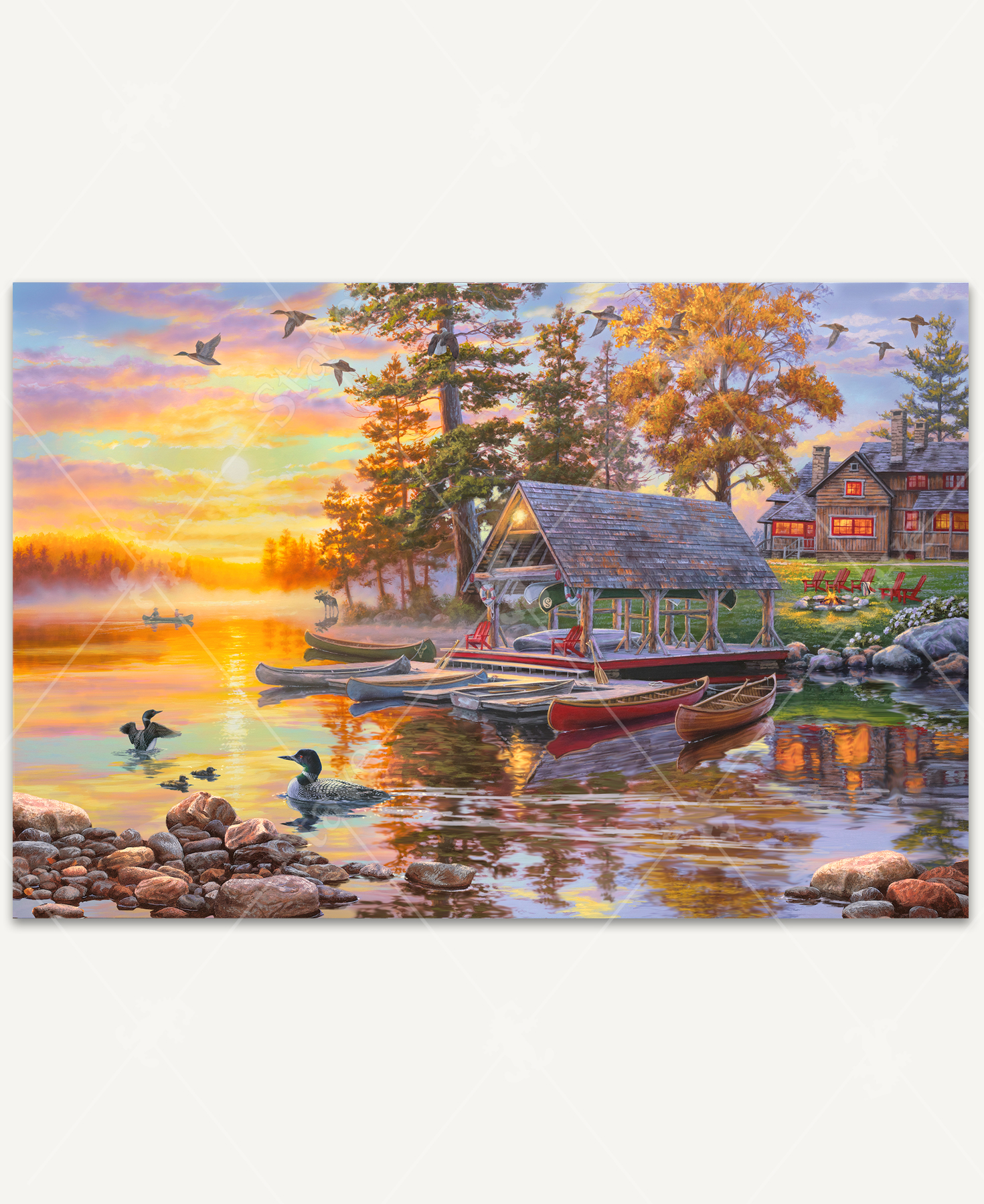 Canoe Camp Buffalo wooden jigsaw puzzle unveils an autumn evening of a lake view property. Two people take a canoe ride on the lake as the sun sets, reflecting vibrant pastel colors on the water. A moose stands on the shore line watching the boat as ducks swim near canoes lining the perimeter of a boat dock. Adirondack chairs surround a fire pit off the side of a cabin.