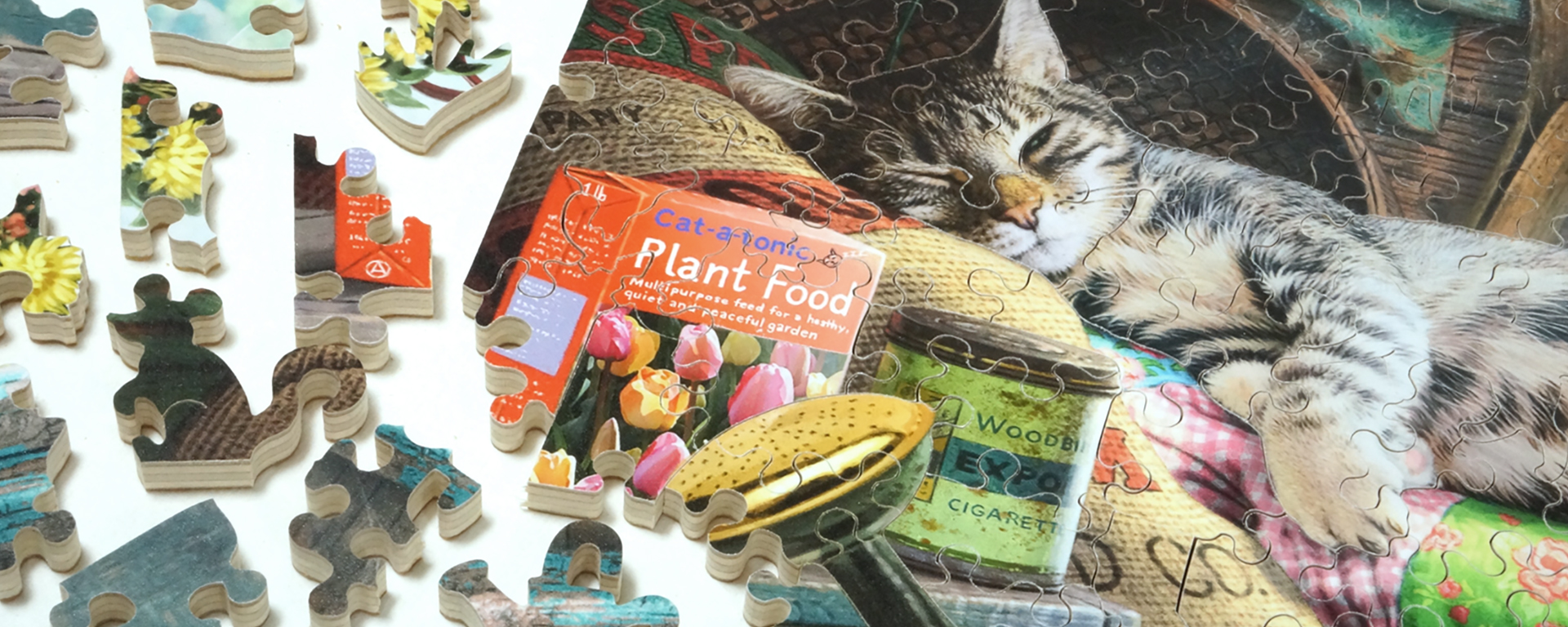 Wooden cat jigsaw puzzle in progress featuring a lounging cat and a whimsy shaped mouse piece.