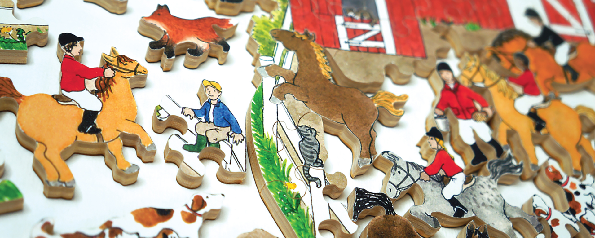 Wooden teaser horse jigsaw puzzle in progress featuring a variety of horse and rider shaped puzzle pieces and a stable.