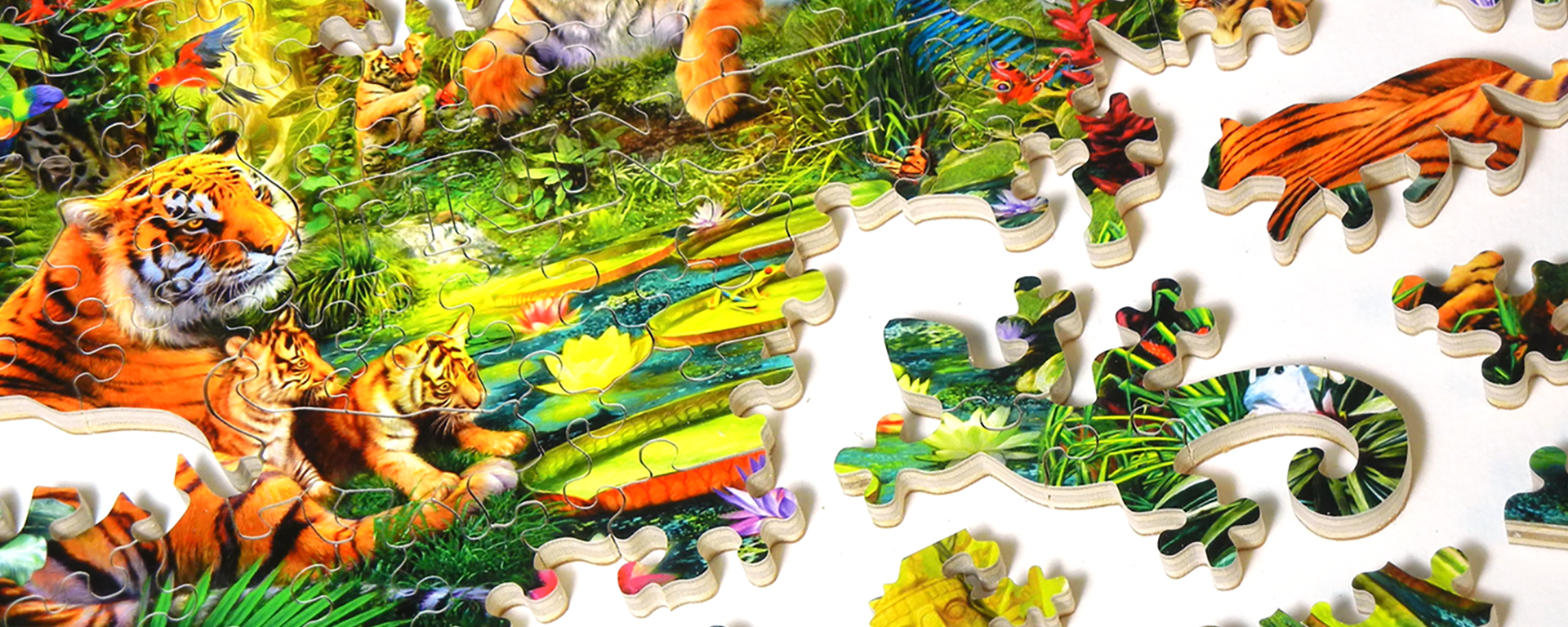 Wooden jungle jigsaw puzzle in progress featuring a mother tigers with their cubs in the jungle and whimsy shaped puzzle pieces of wild cats and chameleons.