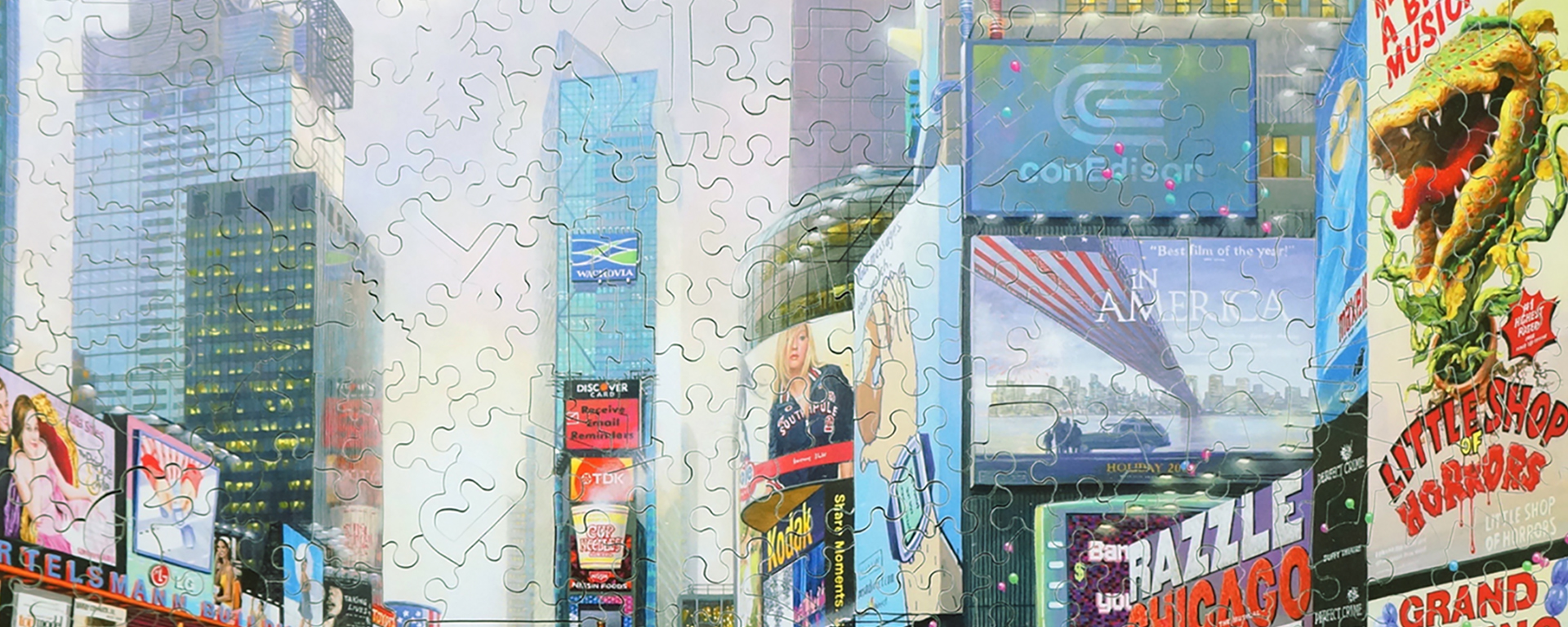 Handcut wooden jigsaw puzzle featuring the buildings and architecture of Times Square with its neon lights and billboards lighting up the buildings.