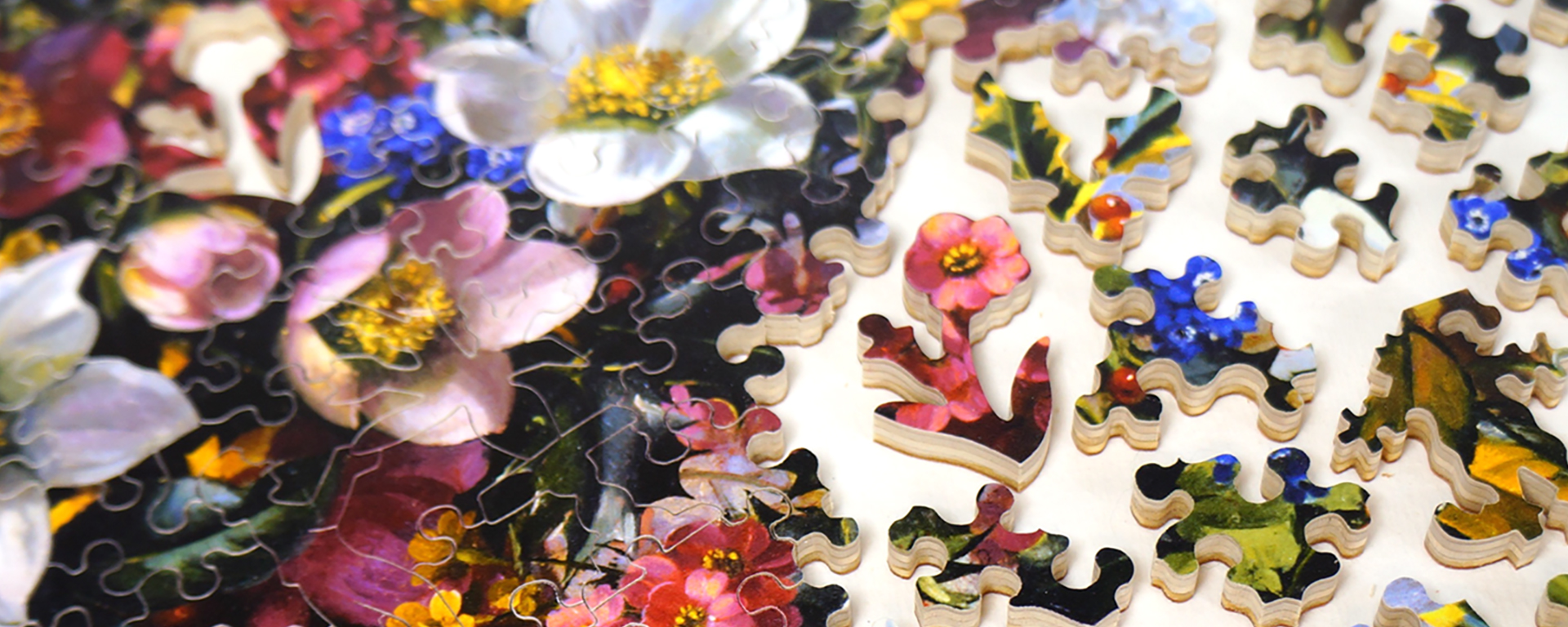 Wooden winter florals jigsaw puzzle in progress featuring a bouquet of white, pink, yellow, and blue flowers.