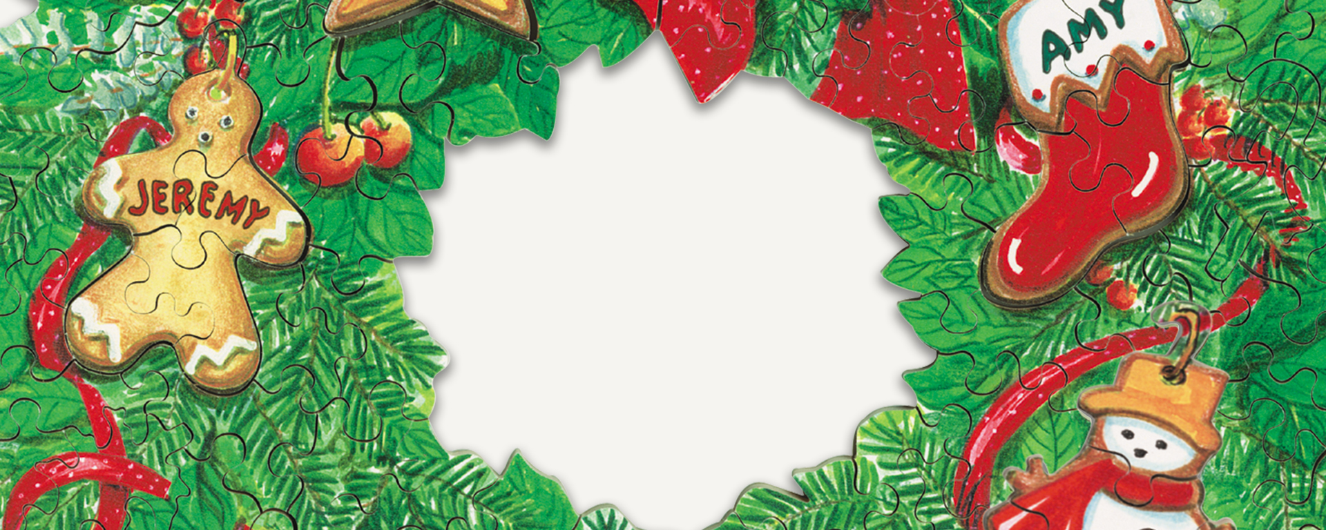 Wooden wreath jigsaw puzzle featuring a red bow and ribbons with personalized name ornaments in the shapes of a gingerbread man, a stocking, and a snowman.