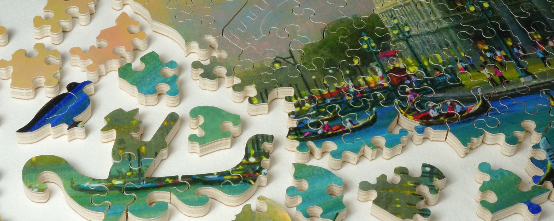 Close up of a wooden Italy puzzle featuring our whimsy shaped pieces in the shape of a a bird and a man in a hat rowing a gondola in a Venice canal.