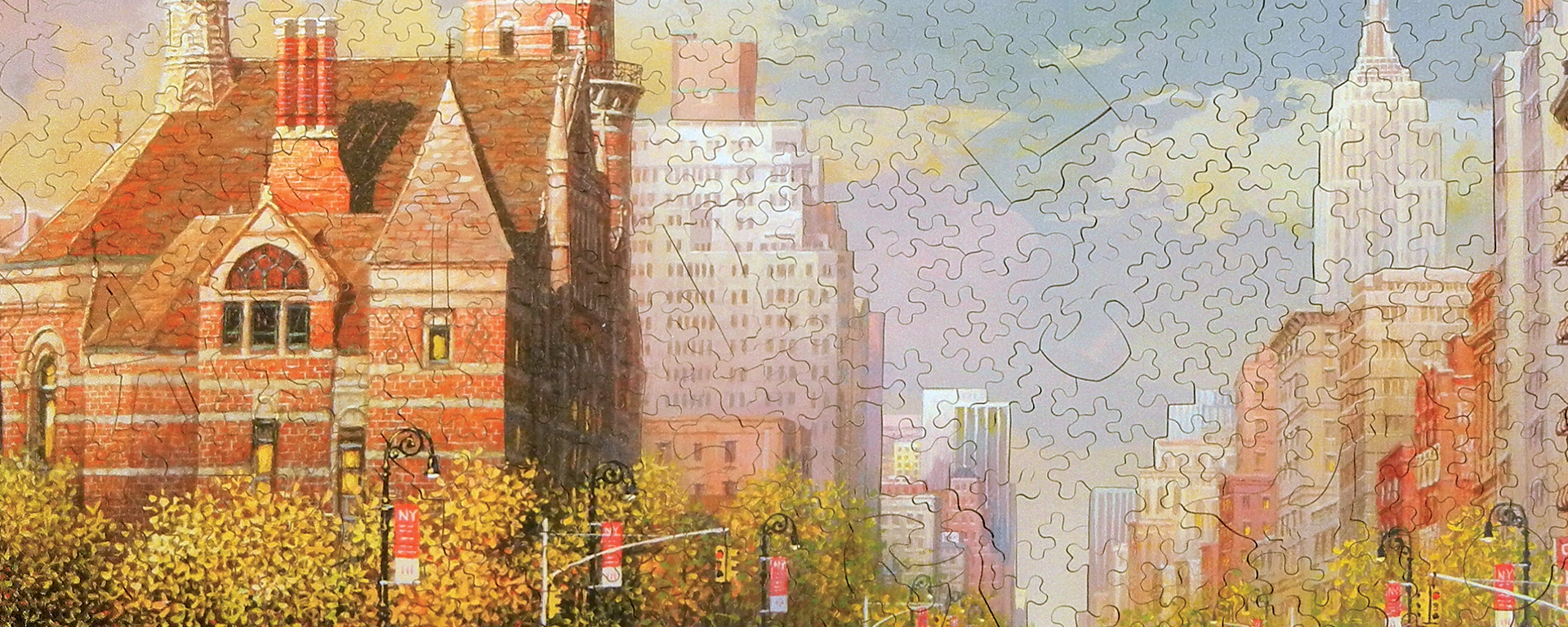 Wooden New York puzzle featuring the different buildings along a busy street in the city.