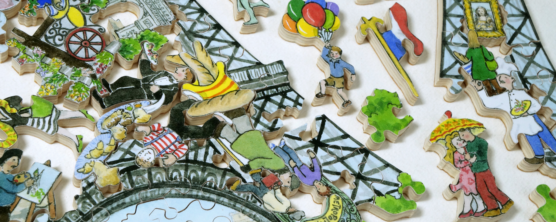 Wooden Paris puzzle featuring the Eiffel Tower and pieces cut out in the shape of people doing a variety of activities.